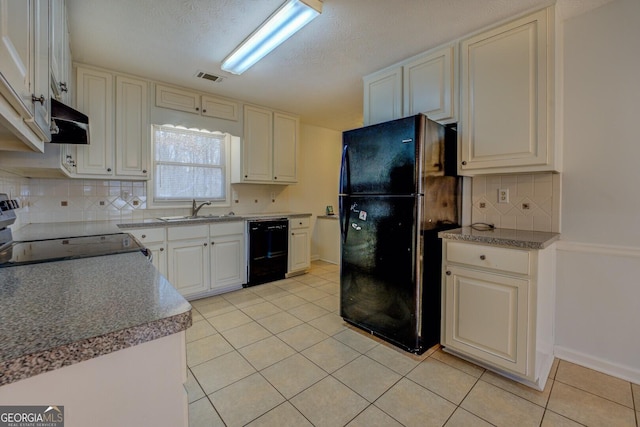 kitchen with tasteful backsplash, a textured ceiling, sink, black appliances, and light tile patterned floors