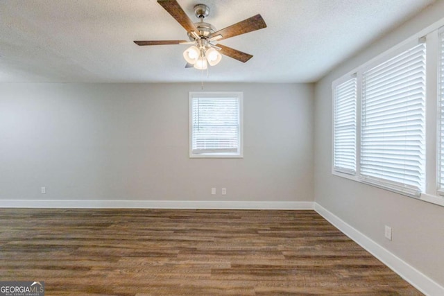 spare room featuring a textured ceiling, dark hardwood / wood-style floors, and ceiling fan