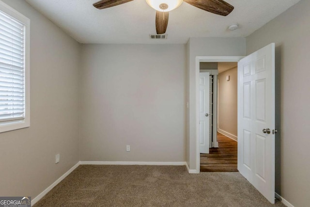 spare room featuring carpet flooring and ceiling fan