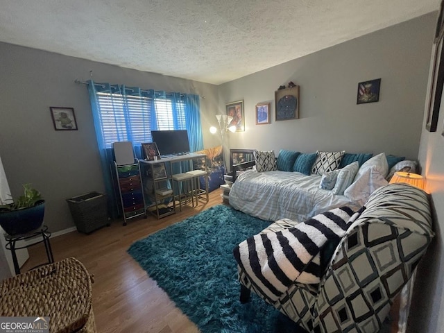 living room with hardwood / wood-style floors and a textured ceiling