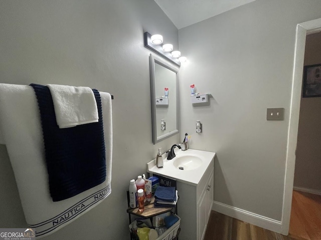 bathroom with hardwood / wood-style flooring and vanity