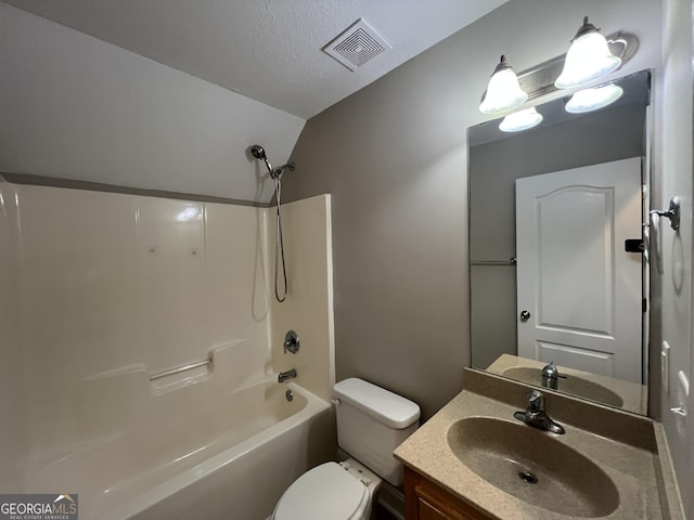 full bathroom featuring vaulted ceiling, a textured ceiling, toilet, vanity, and shower / bathtub combination