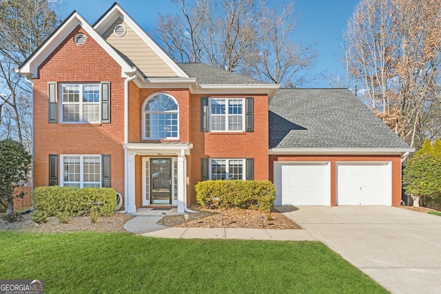 view of front of house with a front yard and a garage