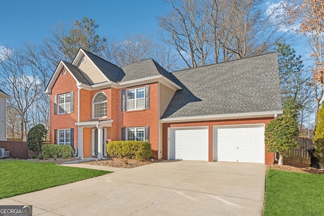 view of front of property with a garage, central AC, and a front yard