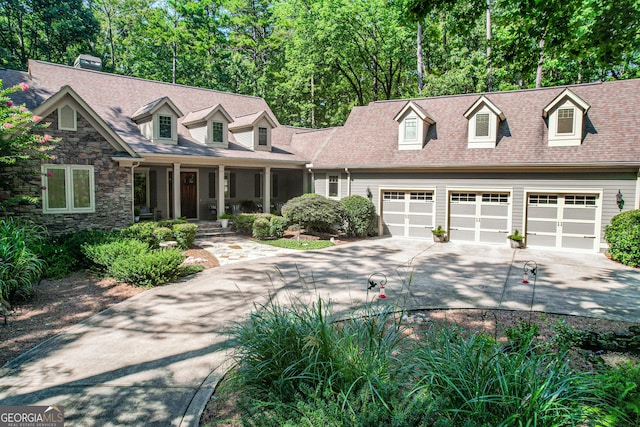 cape cod-style house featuring covered porch