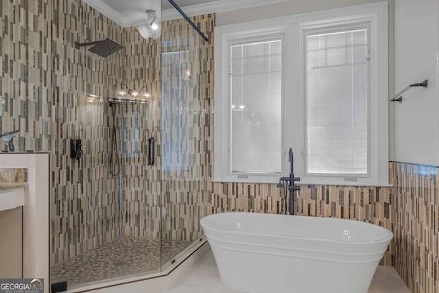 bathroom featuring crown molding, tile walls, and shower with separate bathtub