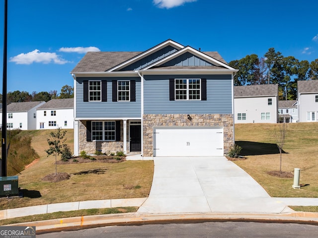 view of front of home with a front lawn and a garage