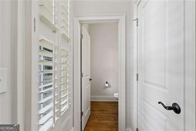 bathroom featuring wood-type flooring and toilet