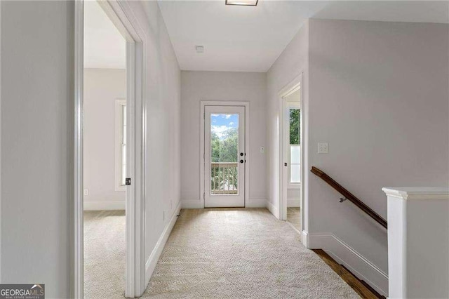 doorway with light colored carpet