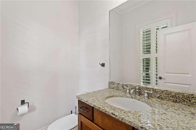 bathroom featuring vanity and toilet