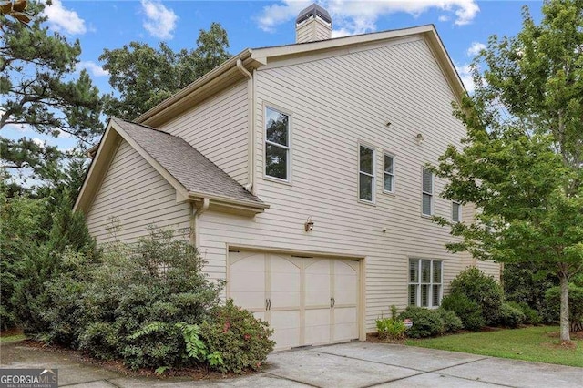 view of side of home featuring a garage