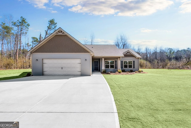 view of front facade featuring a garage, driveway, and a front lawn