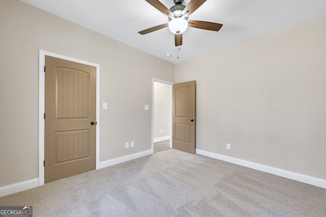 unfurnished bedroom featuring ceiling fan and light carpet