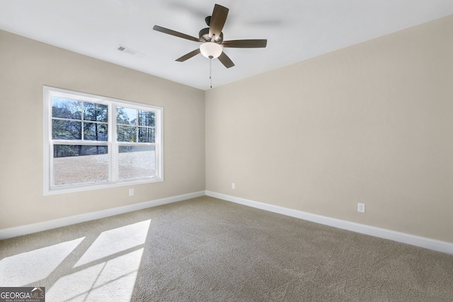 carpeted spare room with ceiling fan