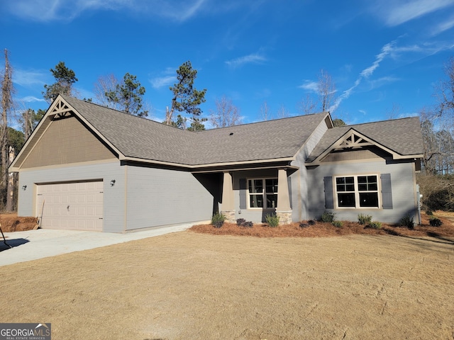 view of front of property featuring a garage and a front lawn