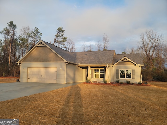 view of front of property with a garage, a front yard, and concrete driveway