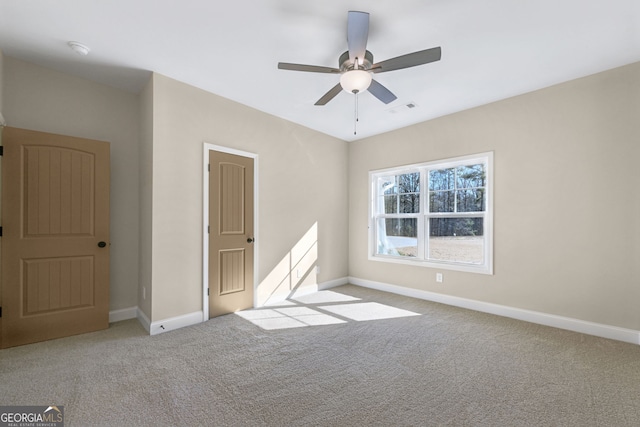 unfurnished bedroom featuring light colored carpet and ceiling fan