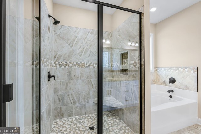 bathroom with a shower with door and vanity