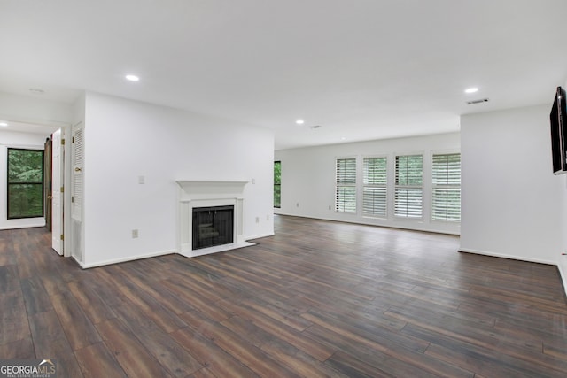 unfurnished living room featuring dark hardwood / wood-style floors