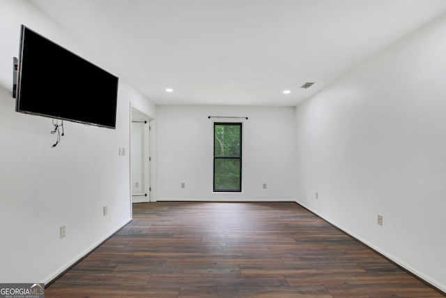 empty room featuring dark wood-type flooring