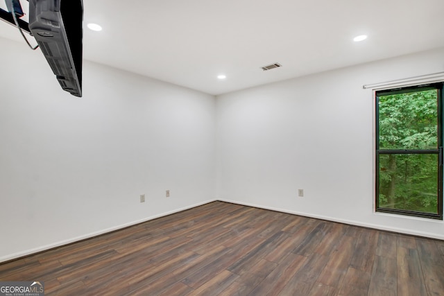 spare room with dark hardwood / wood-style flooring