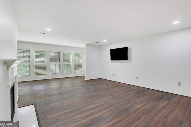 unfurnished living room with dark hardwood / wood-style flooring