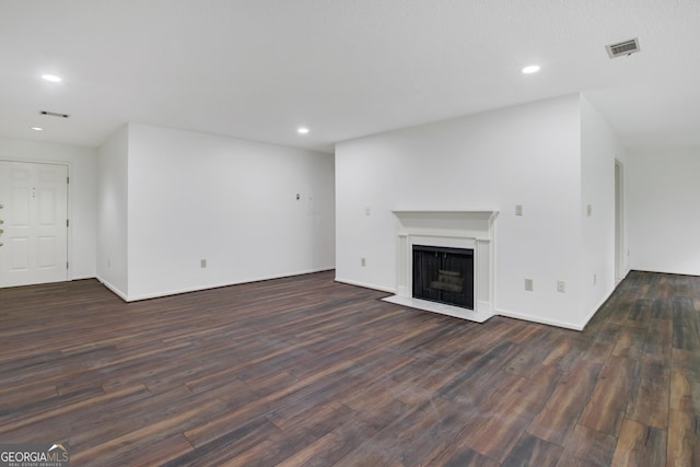 unfurnished living room with dark wood-type flooring