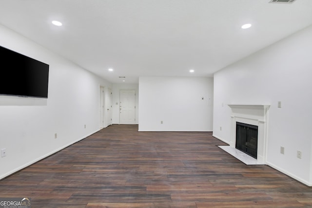 unfurnished living room with dark hardwood / wood-style flooring