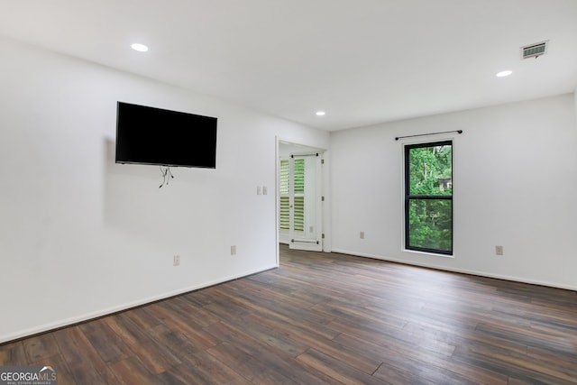 spare room with dark hardwood / wood-style floors