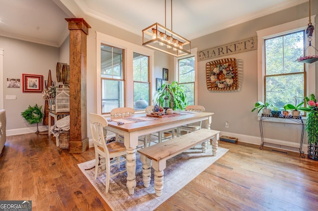 dining space featuring wood-type flooring and ornamental molding