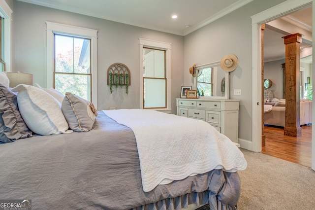 carpeted bedroom with ornamental molding