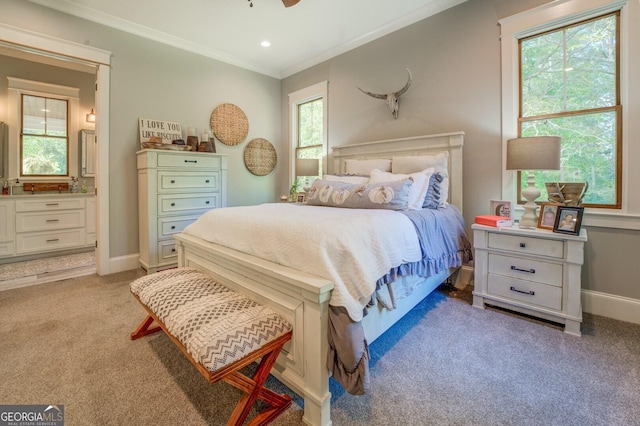 carpeted bedroom with connected bathroom and ornamental molding