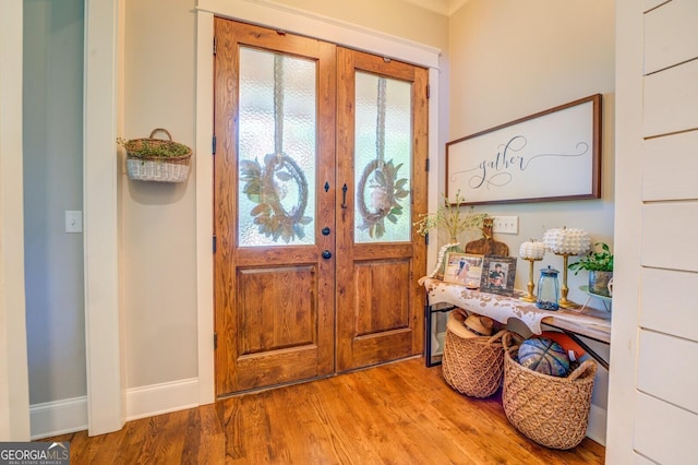 foyer entrance featuring french doors and light hardwood / wood-style floors