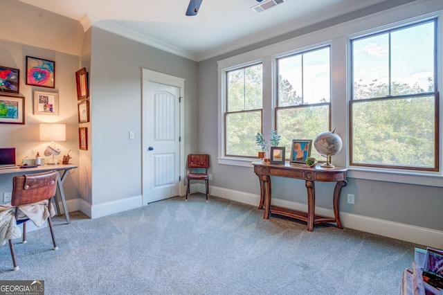 interior space featuring light carpet, ceiling fan, and crown molding