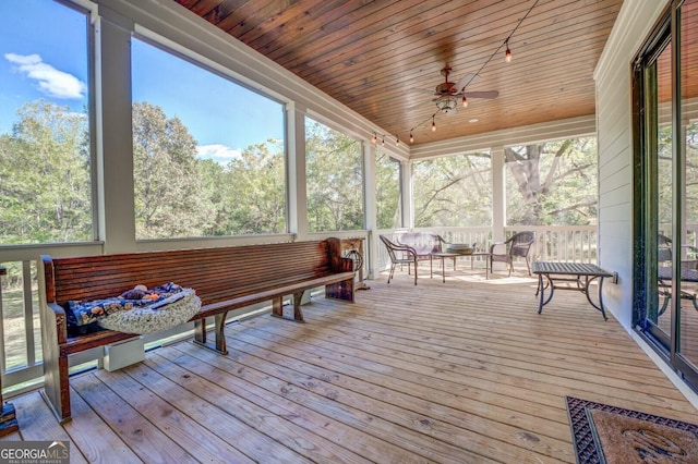 sunroom with a wealth of natural light, ceiling fan, and wooden ceiling