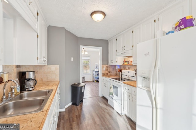 kitchen featuring white cabinetry, sink, dark wood-type flooring, backsplash, and white appliances