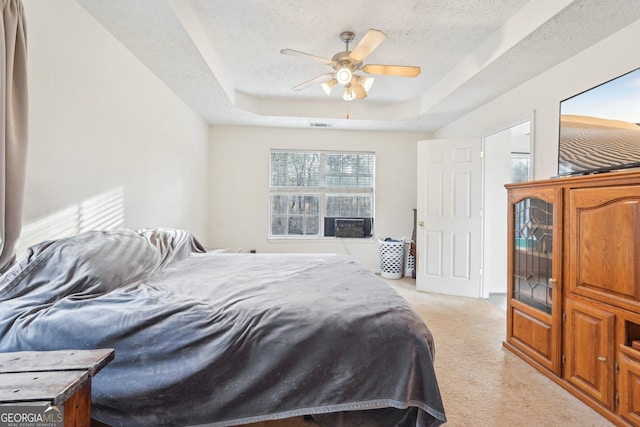 carpeted bedroom featuring a textured ceiling, a raised ceiling, ceiling fan, and cooling unit