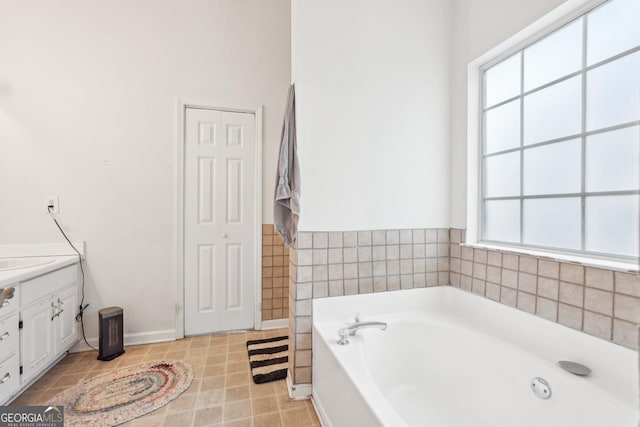 bathroom with vanity and a tub to relax in