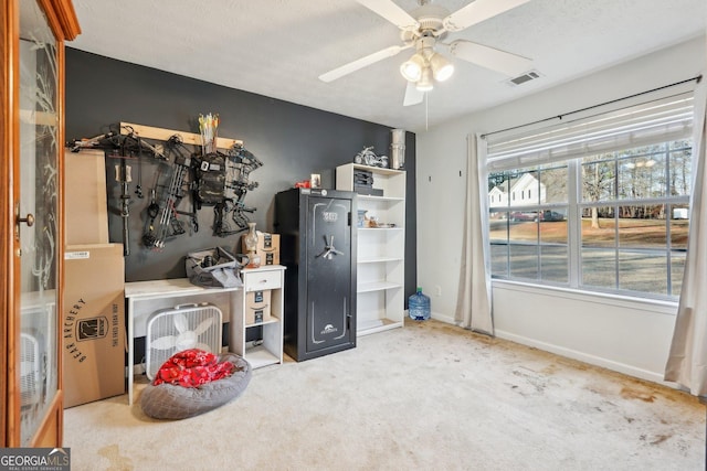 interior space with ceiling fan, light colored carpet, and a textured ceiling