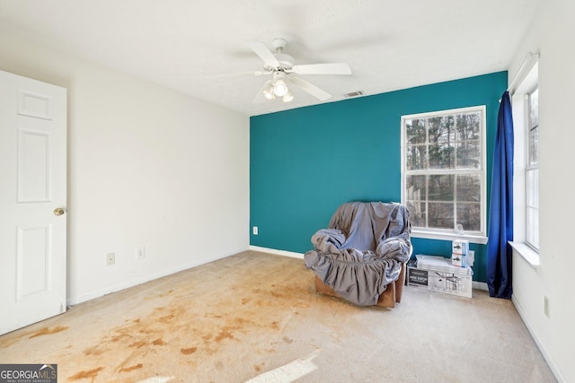 sitting room with carpet and ceiling fan