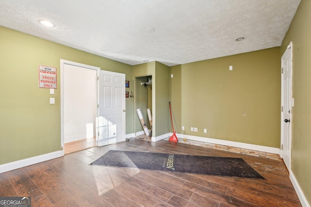 foyer entrance featuring a textured ceiling and hardwood / wood-style flooring