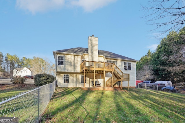 back of property with a yard and a wooden deck