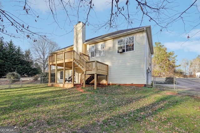 back of property with a wooden deck and a yard