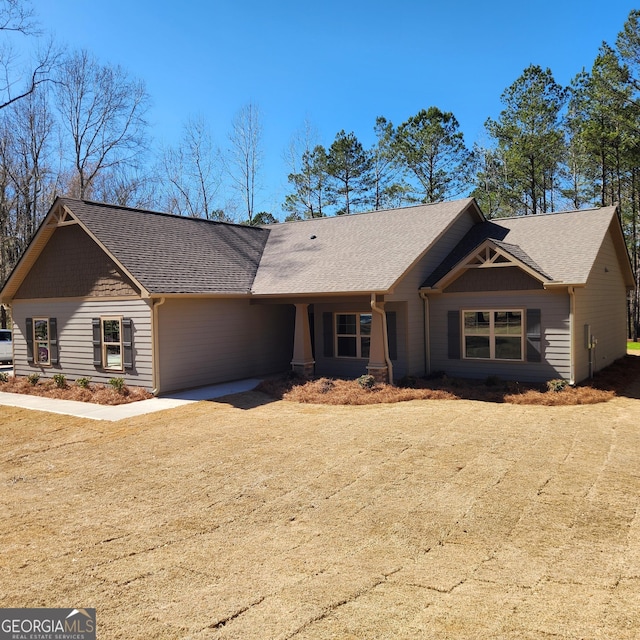 view of front of property with a shingled roof and driveway