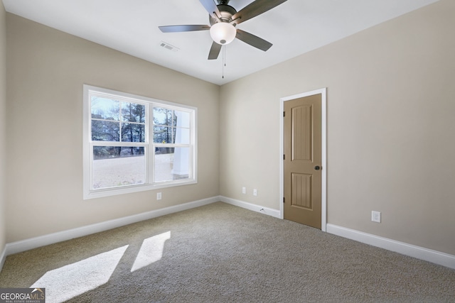 empty room featuring ceiling fan and carpet flooring