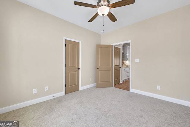 unfurnished bedroom featuring ceiling fan and carpet