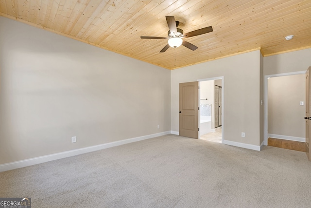 unfurnished bedroom with ceiling fan, light colored carpet, wooden ceiling, and ensuite bath