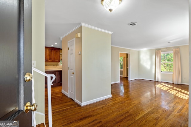 interior space featuring ornamental molding, visible vents, and wood finished floors