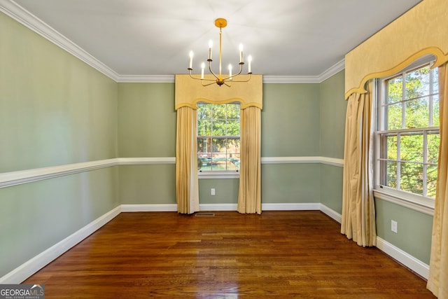 unfurnished dining area featuring dark wood-type flooring, crown molding, and a notable chandelier