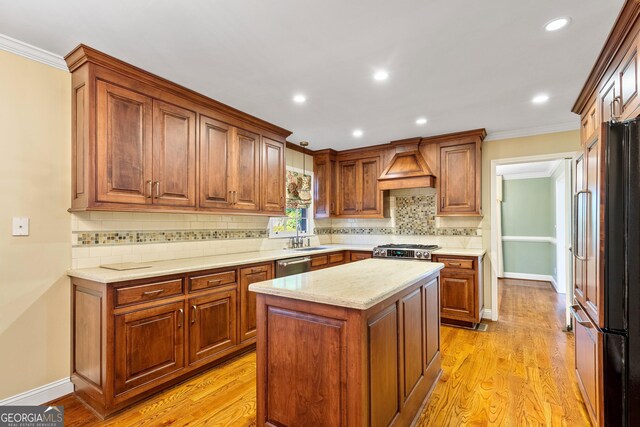 kitchen featuring pendant lighting, stainless steel dishwasher, light wood-type flooring, a notable chandelier, and a kitchen island